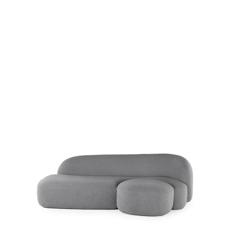A grey AALAND sofa with a soft, organic shape and a small attached seat, designed by Patricia Urquiola.
Fabric upholstered polyurethane