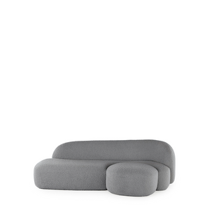 A grey AALAND sofa with a soft, organic shape and a small attached seat, designed by Patricia Urquiola.
Fabric upholstered polyurethane