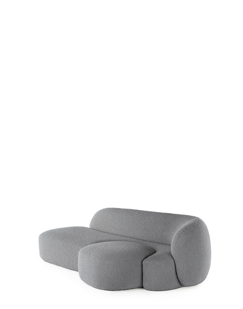 A grey AALAND sofa with a soft, organic shape and a small attached seat, designed by Patricia Urquiola.
Fabric upholstered polyurethane