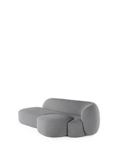 A grey AALAND sofa with a soft, organic shape and a small attached seat, designed by Patricia Urquiola.
Fabric upholstered polyurethane