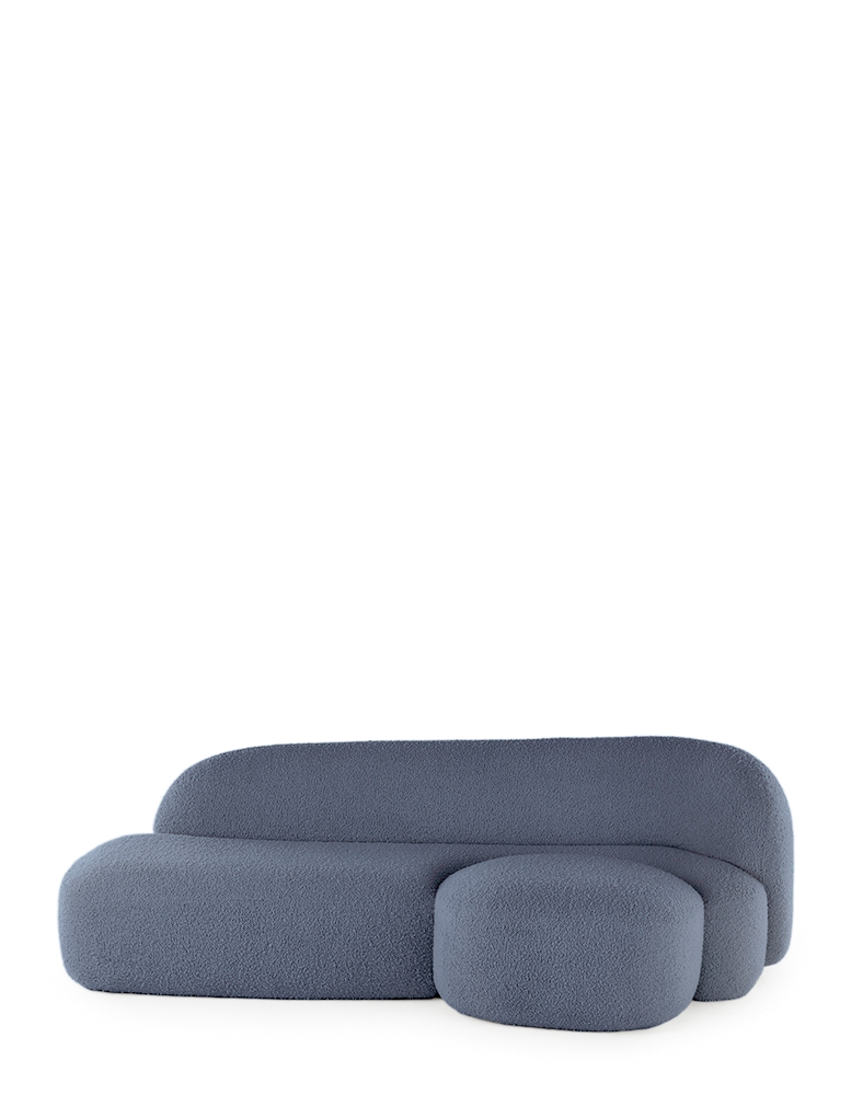 A blue AALAND sofa with a soft, organic shape and a small attached seat, designed by Patricia Urquiola.
Fabric upholstered polyurethane
