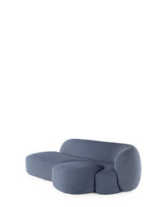 A blue AALAND sofa with a soft, organic shape and a small attached seat, designed by Patricia Urquiola.
Fabric upholstered polyurethane