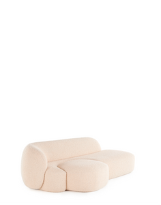 A beige AALAND sofa with a soft, organic shape and a small attached seat, designed by Patricia Urquiola.
Fabric upholstered polyurethane
