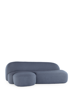 A blue AALAND sofa with a soft, organic shape and a small attached seat, designed by Patricia Urquiola.
Fabric upholstered polyurethane