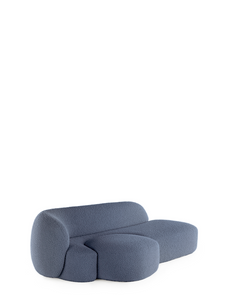 A blue AALAND sofa with a soft, organic shape and a small attached seat, designed by Patricia Urquiola.
Fabric upholstered polyurethane
